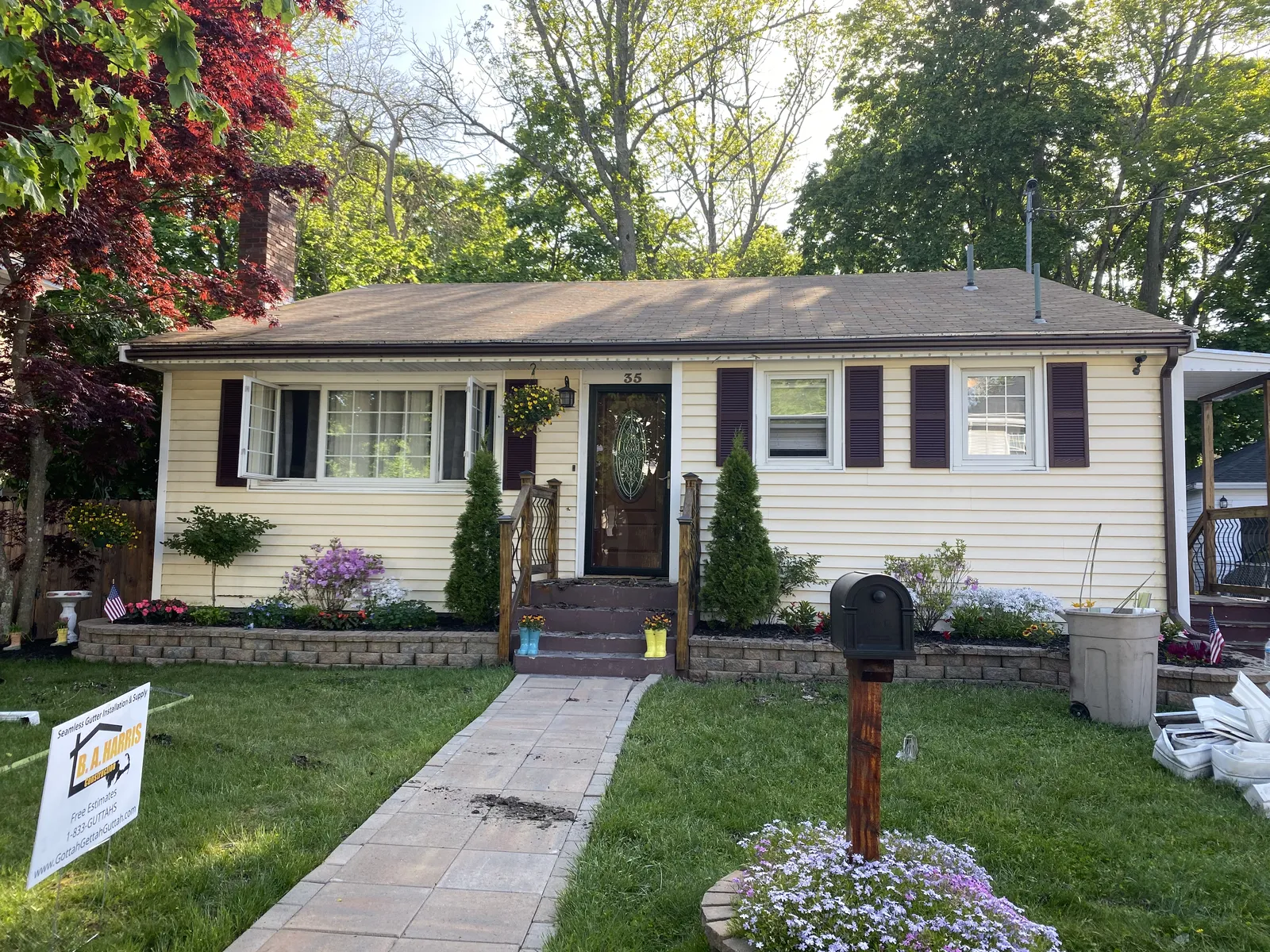 Single-story ranch home with freshly installed seamless gutters in Massachusetts